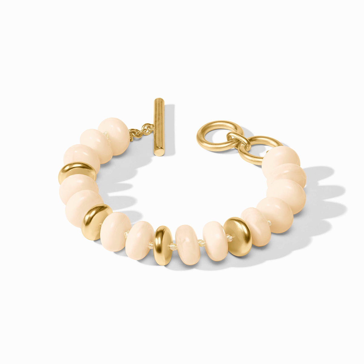 Bracelet with beige beads and gold accents on a white background